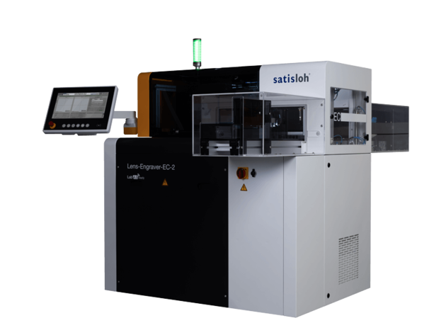 Automated industrial machine with side control monitor and enclosed working area for manufacturing processes.