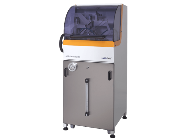 Compact automated industrial machine with transparent housing for precise manufacturing tasks