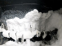 Interior of a container coated with frost and ice buildup.
