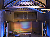 Interior of semiconductor processing equipment with circular wafer holder and metallic chamber components.