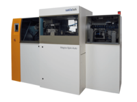 Industrial machine with multiple compartments and control panels, used for optical lens production.