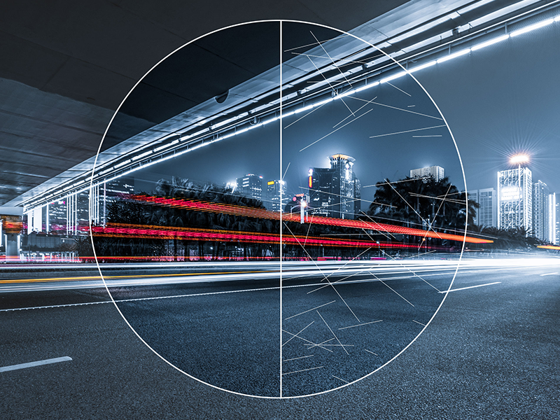 Night cityscape with light trails from traffic under a bridge, overlaid with a circular diagram and mathematical symbols.