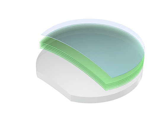 Stack of semiconductor wafers with translucent green-tinted top layers.